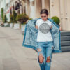 Attractive girl in a jeans jacket and white t-shirt walking along the street. Mock-up. FIESTAS PATRIAS