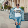Attractive girl in a jeans jacket and white t-shirt walking along the street. Mock-up. FIESTAS PATRIAS