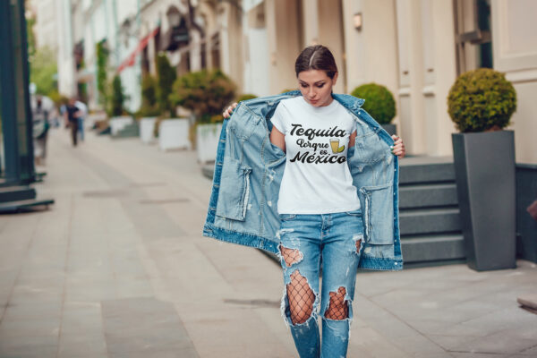 Attractive girl in a jeans jacket and white t-shirt walking along the street. Mock-up. FIESTAS PATRIAS