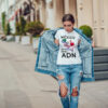 Attractive girl in a jeans jacket and white t-shirt walking along the street. Mock-up. FIESTAS PATRIAS
