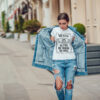Attractive girl in a jeans jacket and white t-shirt walking along the street. Mock-up. FIESTAS PATRIAS