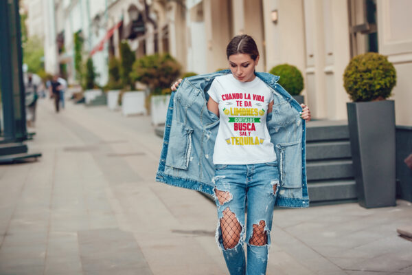 Attractive girl in a jeans jacket and white t-shirt walking along the street. Mock-up. FIESTAS PATRIAS
