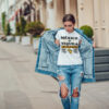 Attractive girl in a jeans jacket and white t-shirt walking along the street. Mock-up. FIESTAS PATRIAS