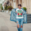 Attractive girl in a jeans jacket and white t-shirt walking along the street. Mock-up. FIESTAS PATRIAS