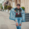 Attractive girl in a jeans jacket and white t-shirt walking along the street. Mock-up. FIESTAS PATRIAS