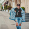 Attractive girl in a jeans jacket and white t-shirt walking along the street. Mock-up. FIESTAS PATRIAS