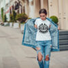 Attractive girl in a jeans jacket and white t-shirt walking along the street. Mock-up. FIESTAS PATRIAS