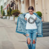 Attractive girl in a jeans jacket and white t-shirt walking along the street. Mock-up. FIESTAS PATRIAS