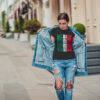 Attractive girl in a jeans jacket and white t-shirt walking along the street. Mock-up. FIESTAS PATRIAS