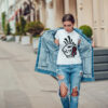 Attractive girl in a jeans jacket and white t-shirt walking along the street. Mock-up. FIESTAS PATRIAS